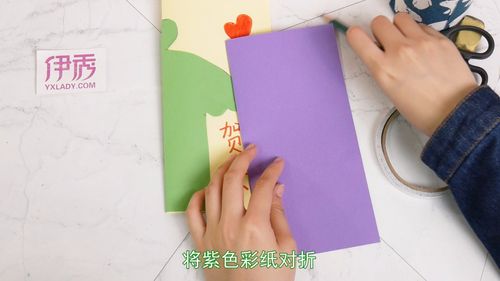 用双面胶粘在一起用彩笔写上贺卡画上爱心将紫色彩纸对折画一个