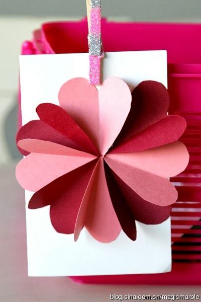 4粉色红色的纸剪成心形拼成一朵花制作成贺卡吧.